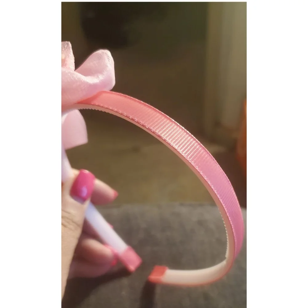 Four Hello Kitty headbands with small figurine